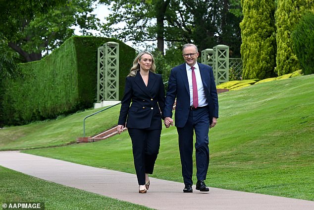 Mrs Haydon and Mr Albanese walk through the lodge gardens after announcing their engagement