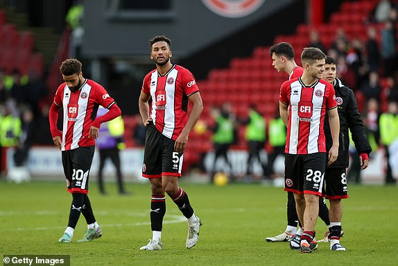 SHEFFIELD, ENGLAND - FEBRUARY 18: Auston Trusty and James McAtee of Sheffield United look dejected after the team's defeat during the Premier League match between Sheffield United and Brighton & Hove Albion at Bramall Lane on February 18, 2024 in Sheffield, England .  (Photo by David Rogers/Getty Images)