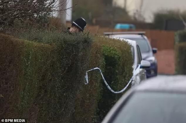 The three children were pronounced dead at the scene, Avon and Somerset Police said today.  In the photo: police at home