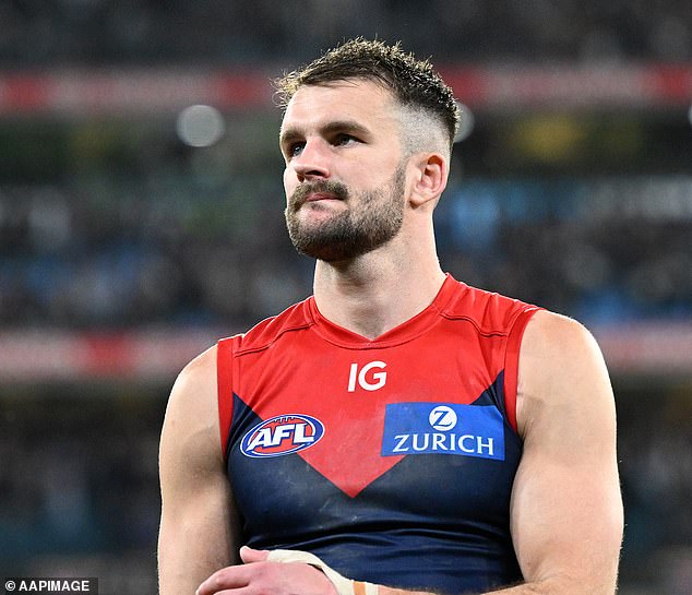 100 AFL players have reportedly been given secret immunity from the sport's three-strike policy (pictured, Melbourne Demons star Joel Smith, who returned a positive cocaine test on match day last year)