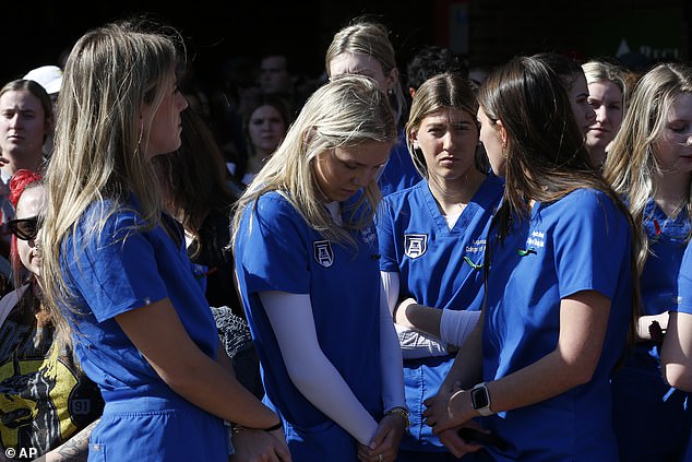 Augusta University College of Nursing students gather to mourn the loss of Laken Riley during a vigil for the nursing student at the Tate Plaza on the University of Georgia campus in Athens, Georgia, Monday, February 26, 2020