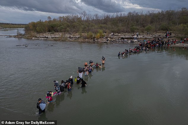 Aerial view of migrants crossing the Rio Grande River from Piedras Negras, Mexico, to Eagle Pass, United States.  December 21, 2023