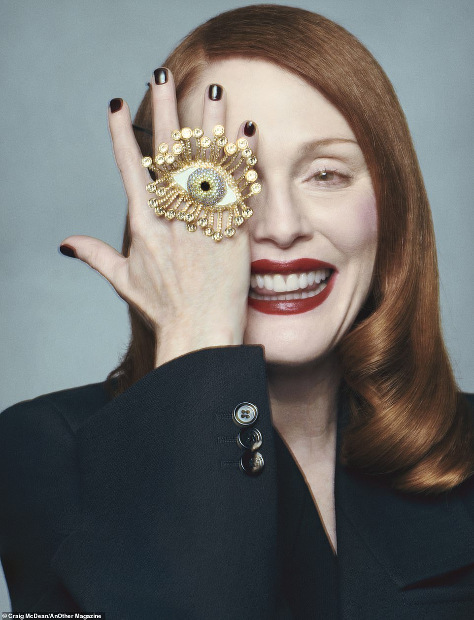 In a more playful photo, the star wears a Bottega Veneta blazer and a large Schiaparelli ring with an eye on it, which she playfully placed over her own eye