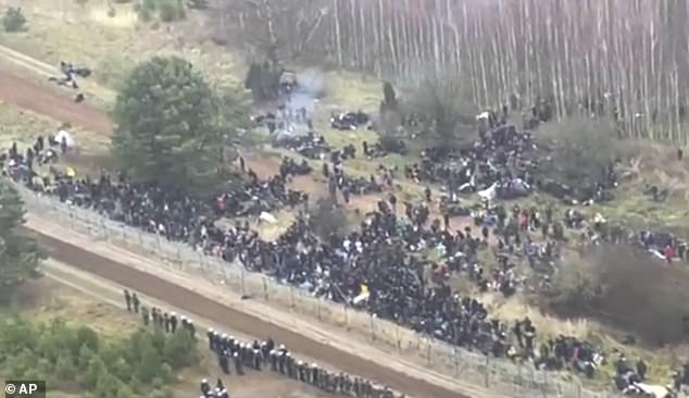 This image, taken from a video from the Polish Ministry of Defense, shows an aerial view of migrants and security personnel gathered at the border Kuznica, Poland, November 8, 2021