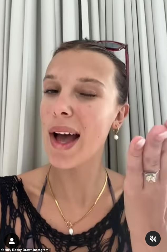 Millie showed off her engagement ring: a diamond with a cushion halo on a pavé band