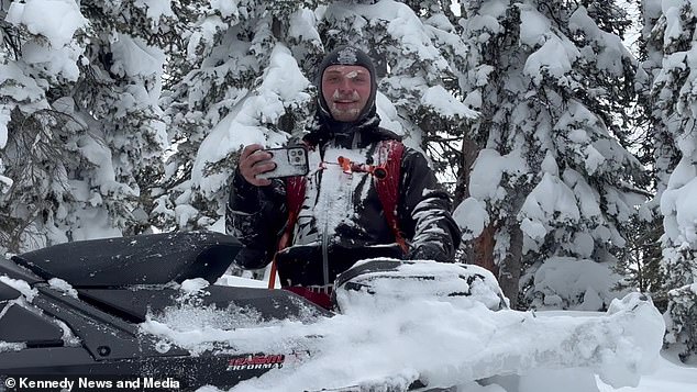 Mason Zak near his snowmobile after the incident.