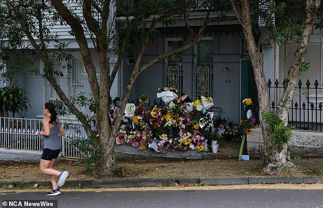 Dozens of tributes have been left at Mr Baird's rented terrace house in Paddington (pictured)