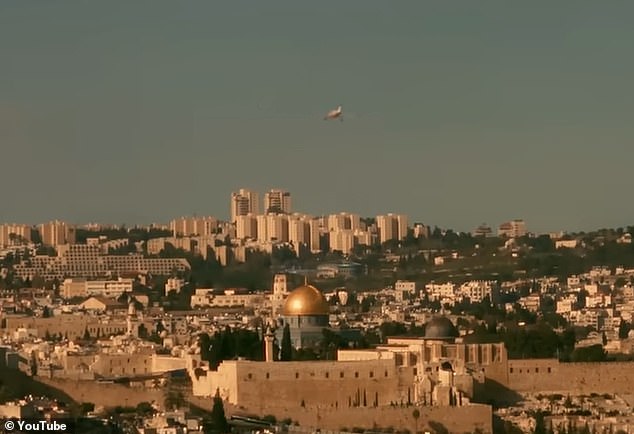 In Bashar Murad's 'Wild West' entry, we see the pop star driving through a West Bank orange grove, flying over the Separation Wall in a plane and looking down on Jerusalem - specifically the golden dome of the Al-Aqsa Mosque.  in the eastern district of the city (photo)