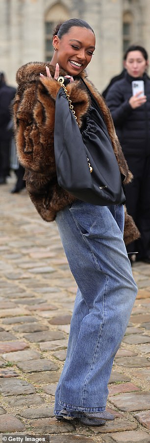 She waved to fans and completed the look with oversized jeans and glittering heels