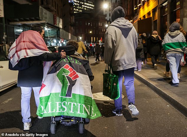 1709306081 746 Pro Palestine protesters mount Wall Streets famous Charging Bull and challenge