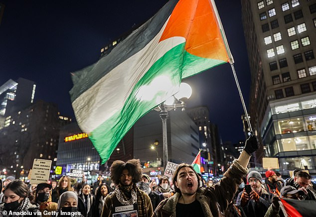 1709306146 55 Pro Palestine protesters mount Wall Streets famous Charging Bull and challenge