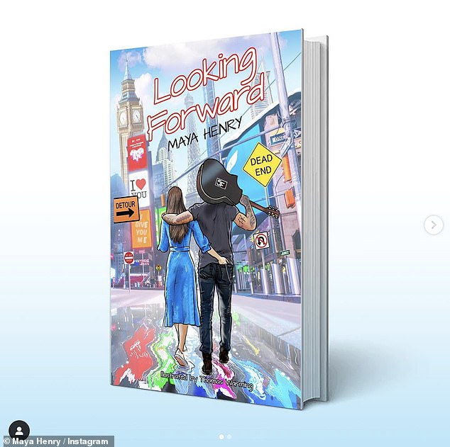 She shared a photo of the cover of the book, called Looking Forward, which shows a brunette woman and a man with a guitar walking with their arms around each other in London.