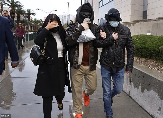 Smirnov left a Vegas courtroom last week flanked by his cousin Linor Shefer, 38, and his girlfriend's son, Nikolay Lavrenyuk, 39. All three tried to hide their faces from cameras.