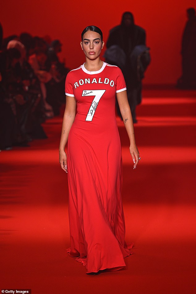 And Georgina paid tribute as she donned her bright red flowing floor-length dress which trailed across the floor as she walked the catwalk in the French capital.