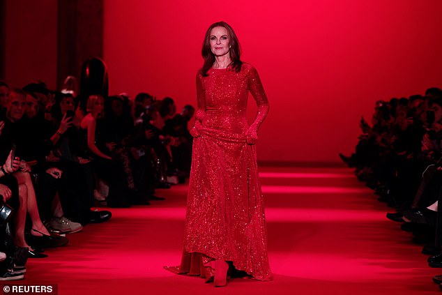 Marcia, dressed from head to toe in blood red, wore a beautiful, dazzling floor-length dress with long sleeves ending in gloves