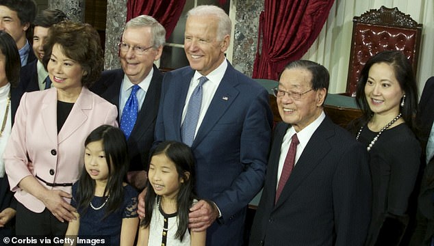 Angela Chao (far right) is pictured in 2015 with her sister, former Secretary of Transportation Elaine Chao (left), her brother-in-law Mitch McConnell (second from left), now President Joe Biden (center), and her father.  James Chao (second from right)