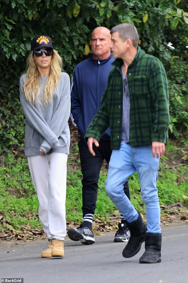 Meanwhile, the actor wore a blue track jacket with white stripes down the sleeves, along with black sweatpants, striped socks and black sneakers.