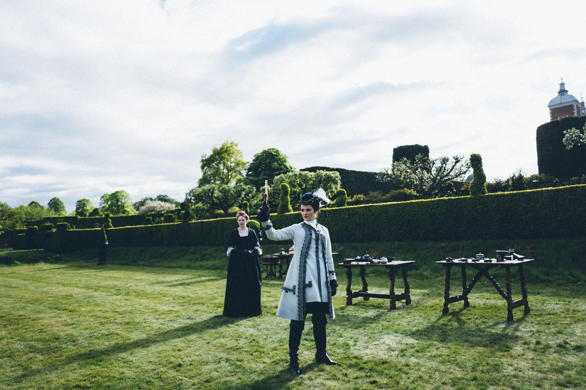 Rachel Weisz fires a gun as Emma Stone watches in The Favorite