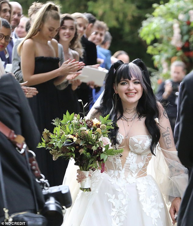 People applaud after the wedding ceremony at St Mary's church in Burford