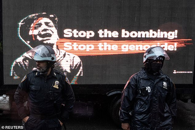 Police officers stand during a protest billed by organizers as the 'Million March for Gaza', a global day of action against the upcoming Israeli operation against Rafa