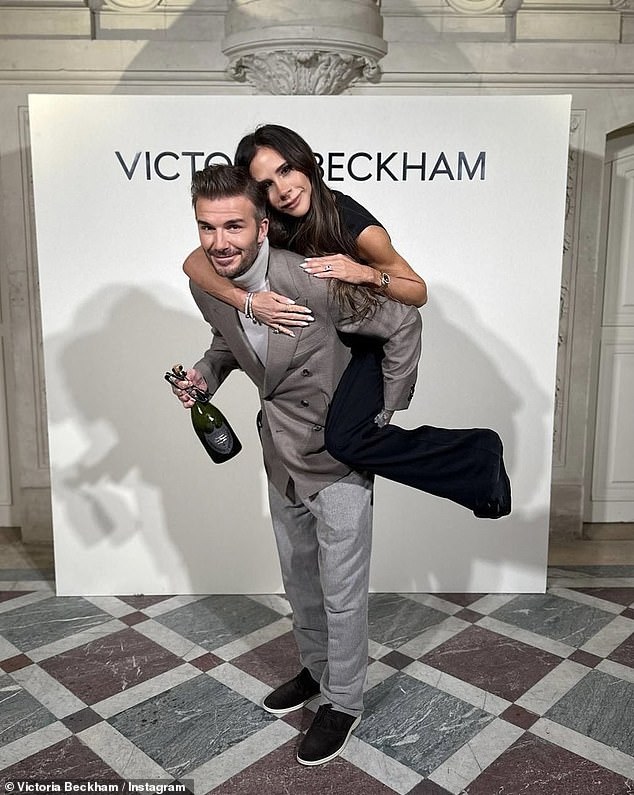 1709427231 875 David Beckham chivalrously holds an umbrella for wife Victoria as