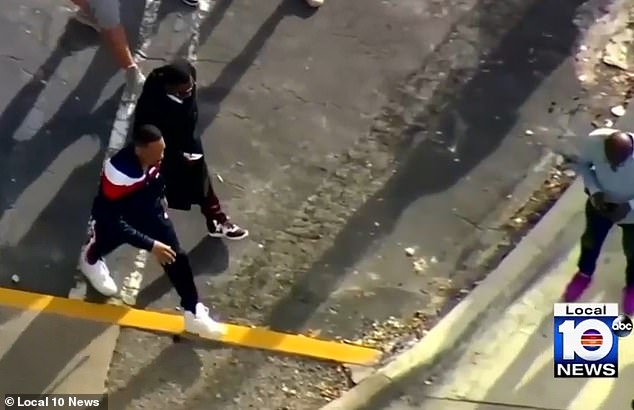 Will Smith, left, and Martin Lawrence walk across the street during filming