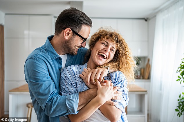 Hugs or just holding hands work, researchers say, because physical contact increases women's body satisfaction (file photo)