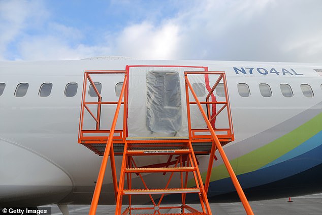 Plastic covers the exterior of the fuselage plug area of ​​Alaska Airlines Flight 1282 Boeing 737-9 MAX after it lands safely