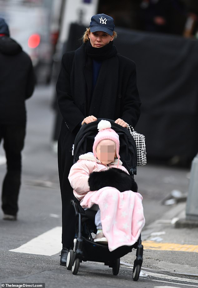 The parents bundled up to brave the cold Big Apple weather as they took their five-year-old bundle of joy for a walk in a stroller