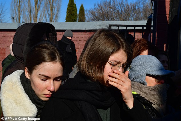 Mourners following the hearse in Moscow threw red carnations as it passed and could be heard shouting: 'Putin is a murderer' and 'Russia will be free'