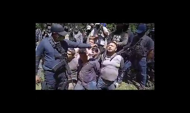 An alleged Los Tlacos gang member points his gun at one of the twenty members of La Bandera in 2021