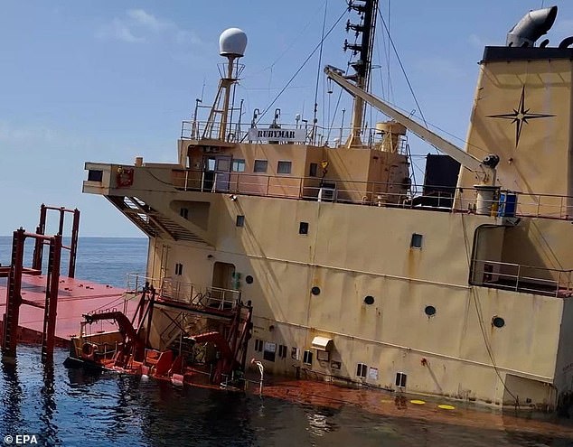 A distribution photo from Yemen's Al-Joumhouriya TV shows the cargo ship, Rubymar, sinking after being damaged in a missile attack by the Houthis in the Red Sea