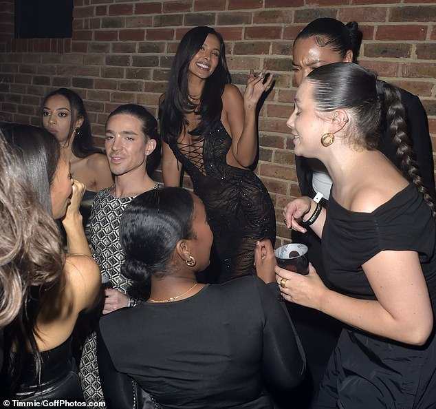 She was all smiles as she posed with a group of friends in the audience