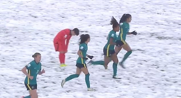 The Australian women celebrate in the snow after their victory over the South Korean Republic in Uzbekistan