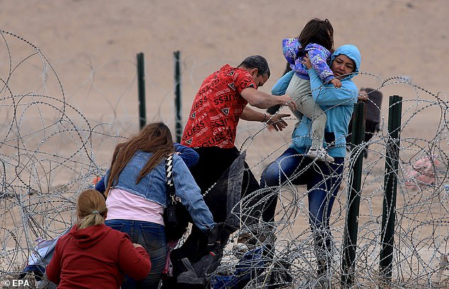 Migrants cross the Rio Grande on Thursday, on the border separating Mexico from the United States, in Juarez City, Mexico