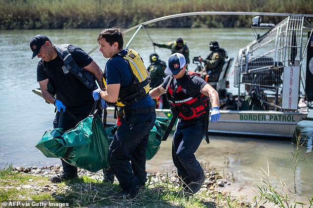 Firefighters (from left) Rodrigo Pineda, William Dorsey and Lt. Julio Valdes of the Eagle Pass Fire Department retrieve the body of a drowned migrant from the Rio Grande River in Eagle Pass, Texas, on Friday