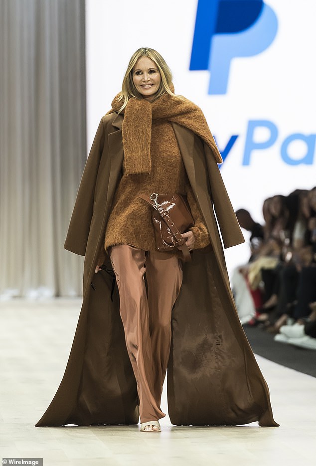She threw on a loose brown coat over it and added a touch of drama as she took off her sunglasses