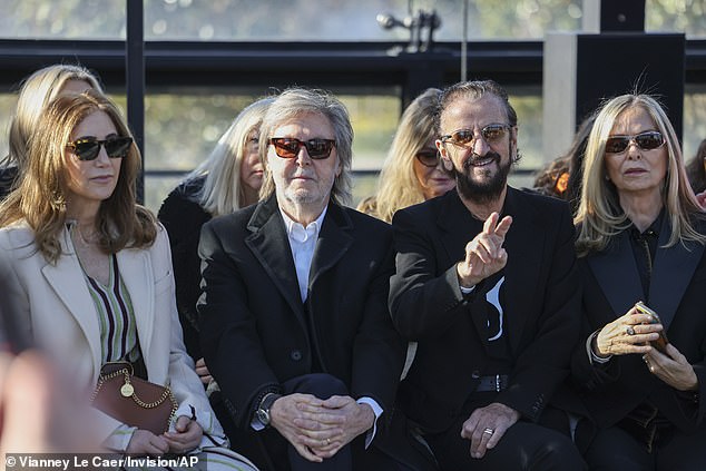 Paul sat next to his wife Nancy, who looked stunning in a striped Stella creation