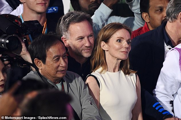 Horner stands behind his wife as Red Bull celebrates taking first and second place in the first race of the season