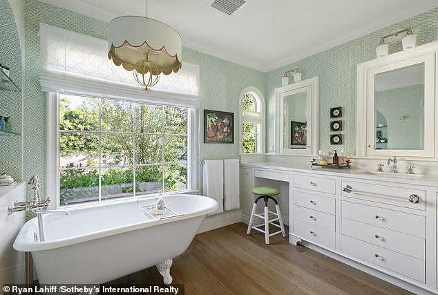 She originally purchased the home, which was built in 1926, for $2.3 million in 2019. One bathroom features a claw-foot tub and separate tiled shower, built-in sink and dual mirrors.