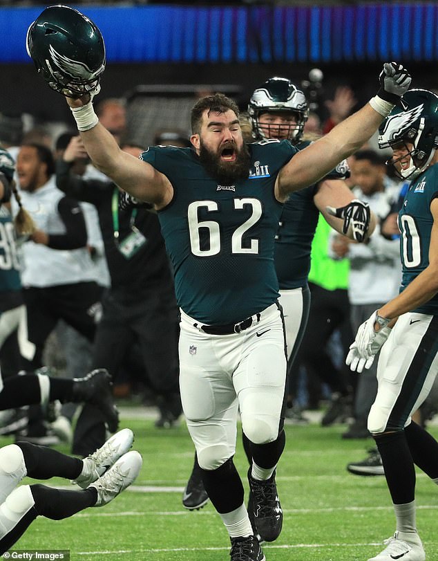 Kelce raises his arms after winning the Super Bowl with Philly against the Patriots in 2018