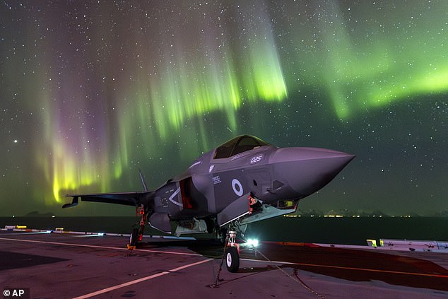 An F-35B Lightning jet is parked in a cockpit of the Royal Navy aircraft carrier HMS Prince of Wales, under the Northern Lights near the coast of Norway, Sunday, March 3, 2024