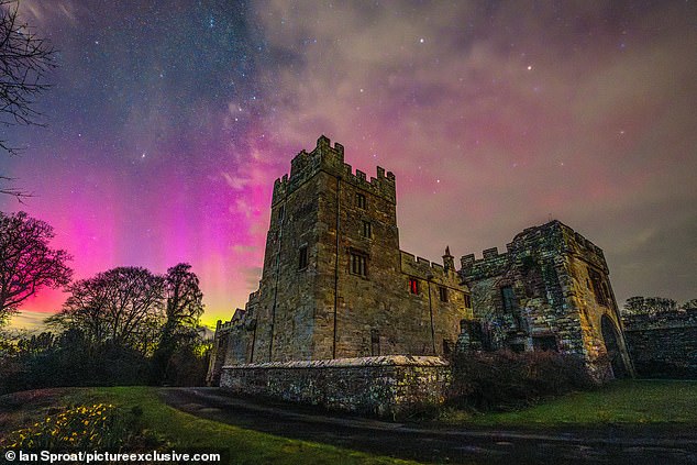 The Northern Lights are most commonly seen over places closer to the Arctic Circle, such as Scandinavia and Alaska, so any sighting over Britain is a treat for skygazers.  Pictured: Naworth Castle in Cumbria, March 3, 2024