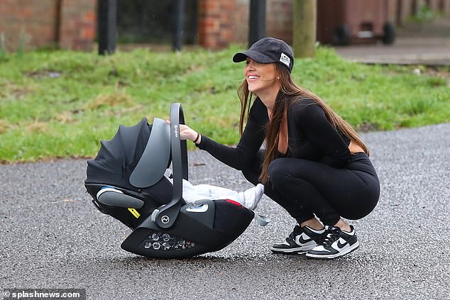 The 33-year-old showed off her toned figure in a black crop top, which put her ample cleavage and flat stomach on full display