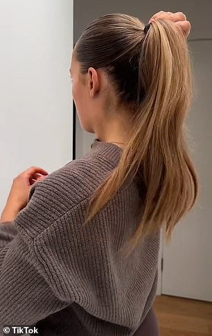 The beauty guru took a hair tie and made a big ponytail with all her hair