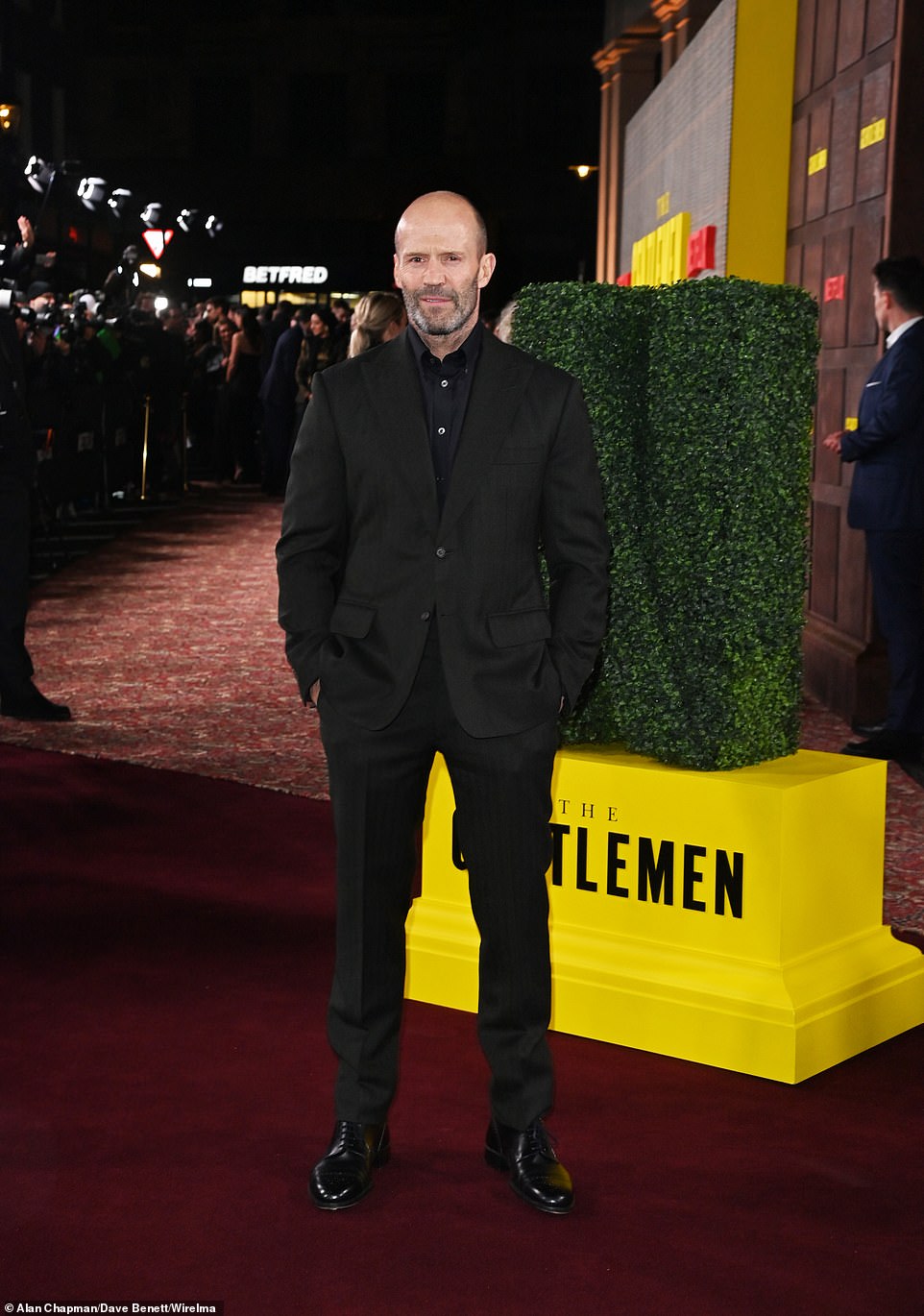 Jason Statham looked sharp in a black suit with matching shirt and shoes