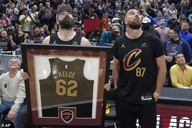 Jason and Travis looked at the screen that showed a tribute video for the Eagles