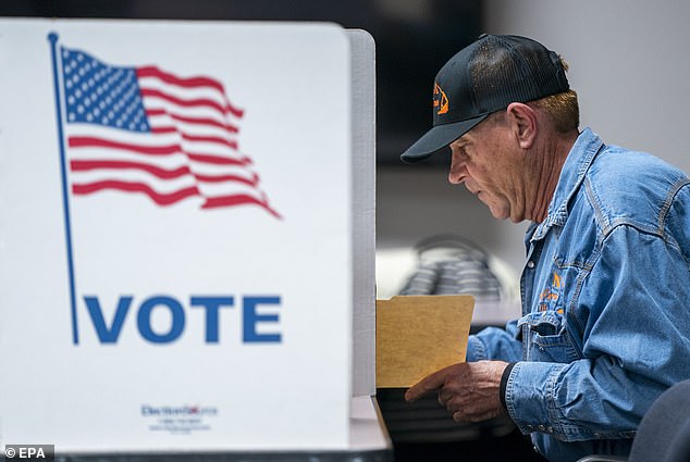 A voter fills out his ballot at the Fairfax County Government Center polling station in Fairfax, Virginia, USA, March 5, 2024. 'Super Tuesday' voters in 15 states and territories will cast their ballots for 2024 United States presidential candidates