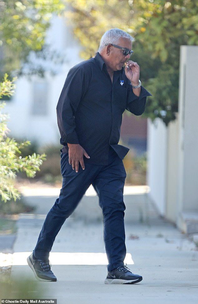 Mr Kerr pulled up outside his home in a Volkswagen with a cigarette in his mouth before tearing up a box for recycling and taking bins off the road