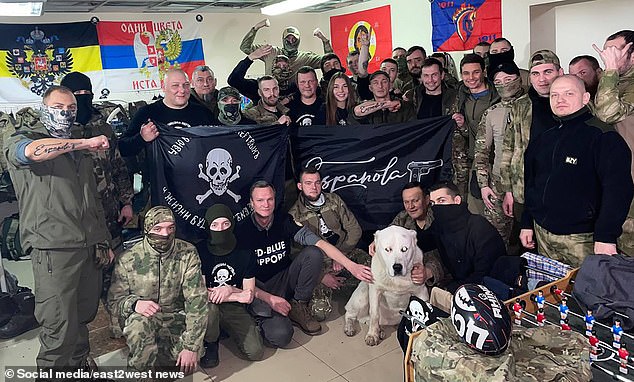 Russians in military uniforms hold Española signs in the barracks, undated